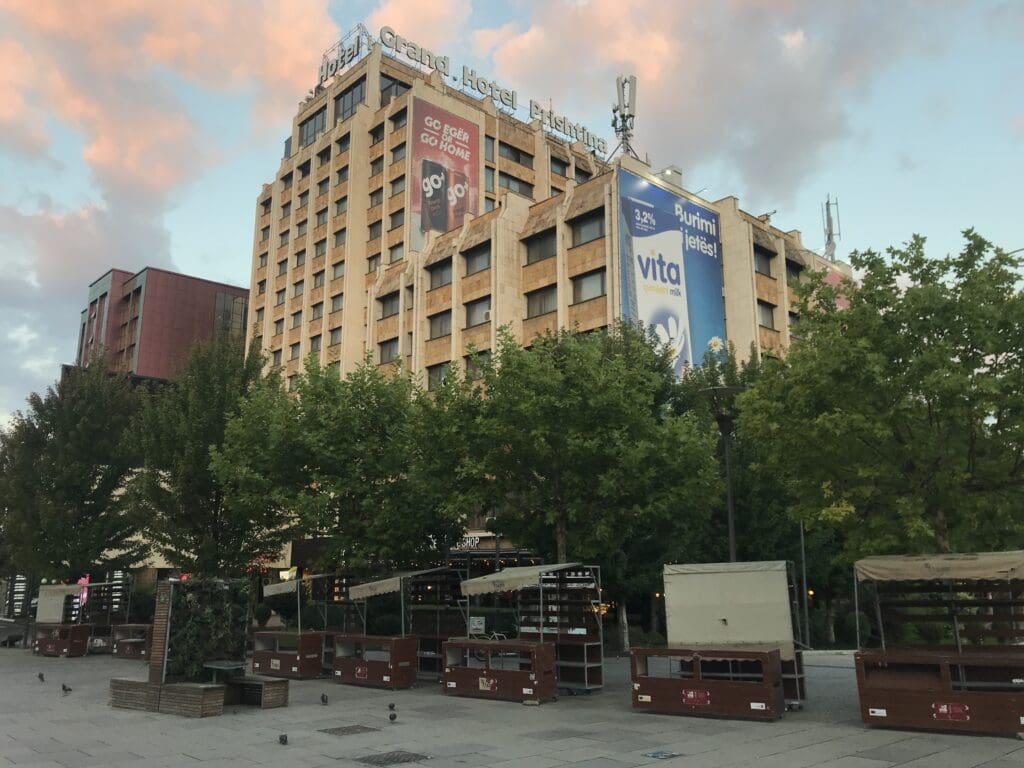 a building with trees and a few signs on it