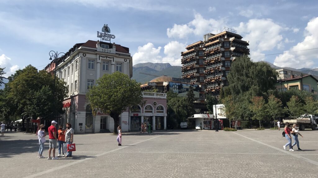 a group of people walking in the main square in Peja, Kosovo during a day trip