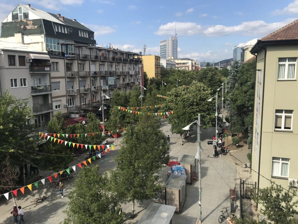 a street with trees and flags