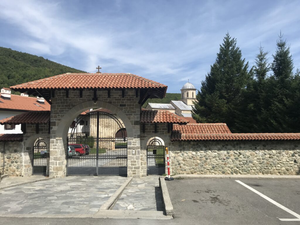 a stone gate with a stone wall and a stone gate