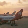 a group of airplanes parked on a runway