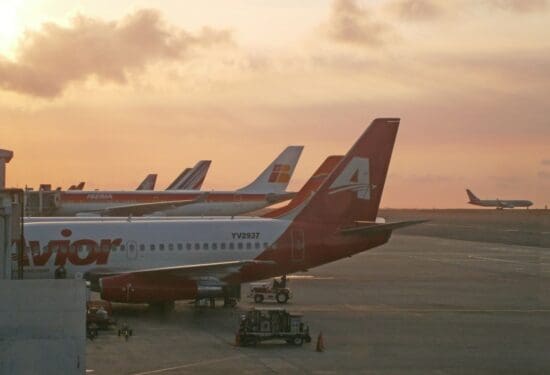 a group of airplanes parked on a runway