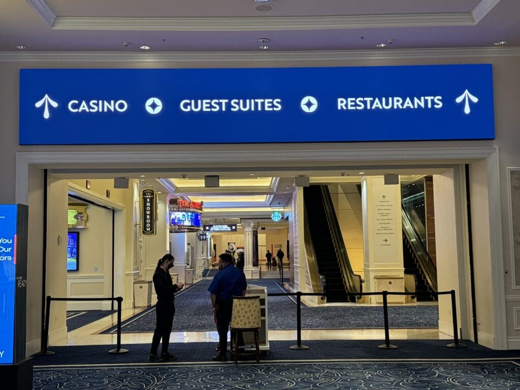 a group of people standing in front of a sign