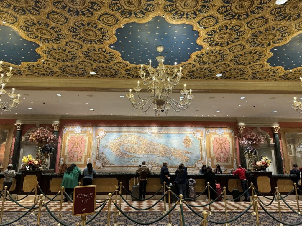 a group of people standing in front of a large ornate wall