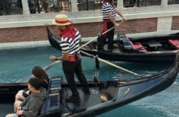 a group of people in gondolas in a canal