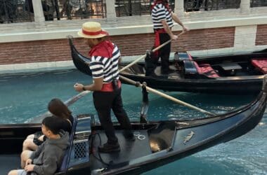 a group of people in gondolas in a canal