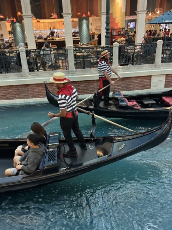 a group of people in gondolas in a canal