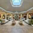 a large room with a christmas tree and chairs at the Hilton San Diego Del Mar