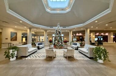 a large room with a christmas tree and chairs at the Hilton San Diego Del Mar