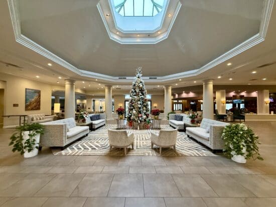 a large room with a christmas tree and chairs at the Hilton San Diego Del Mar