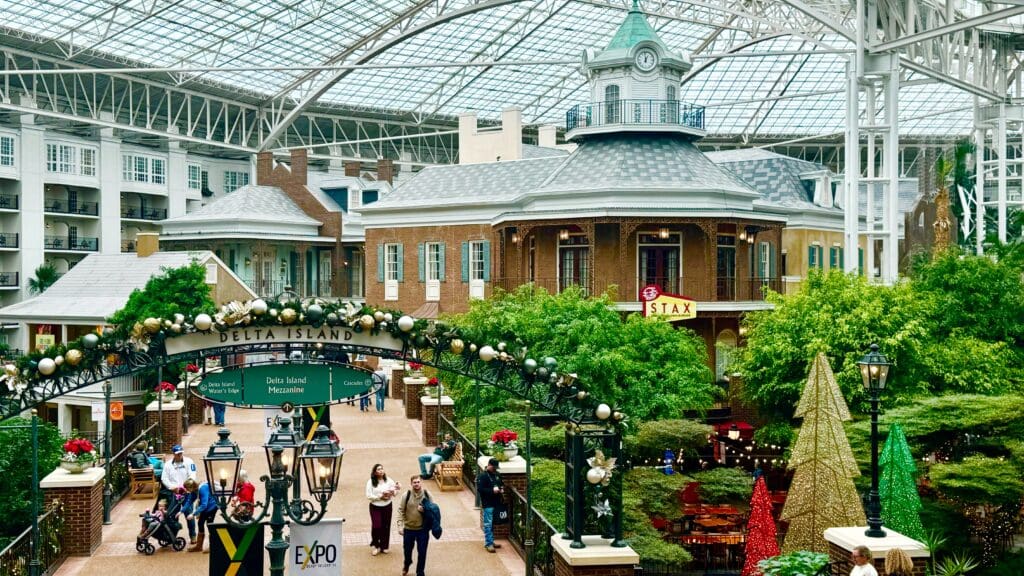 a group of people walking in a mall with Gaylord Opryland Resort & Convention Center in the background