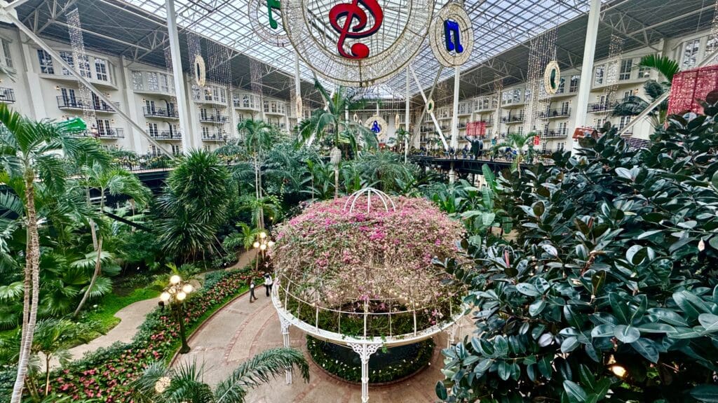 a large indoor garden with a large ceiling and a large building with plants