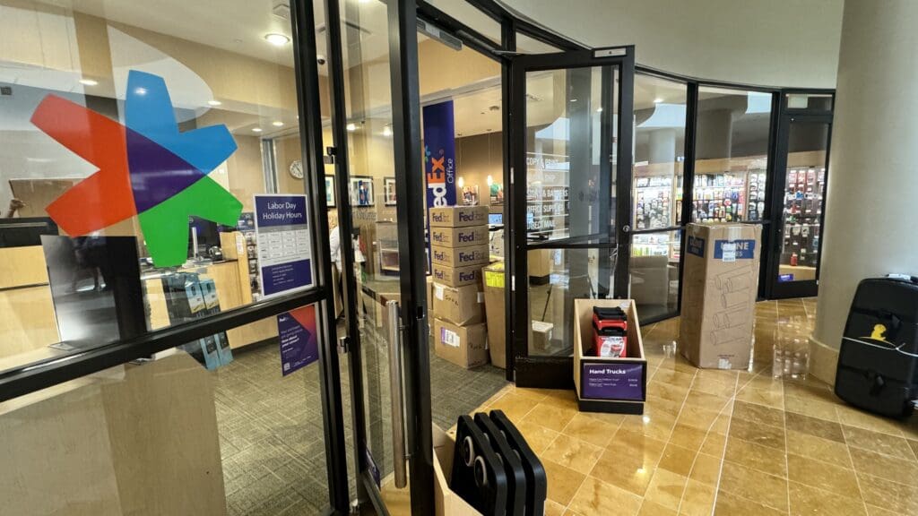 a glass door with a box of luggage in front of it