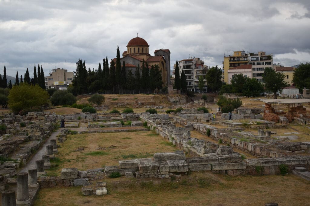 a ruins of Kerameikos with a building in the background