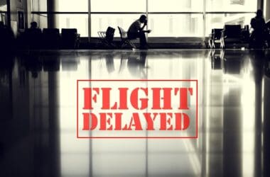 a man sitting in a chair in an airport