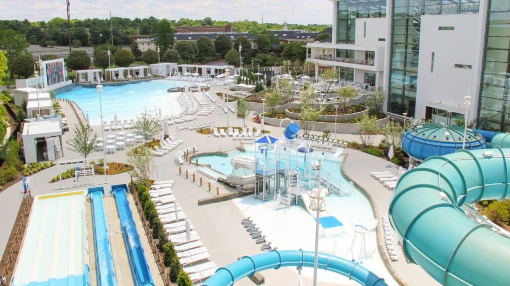 a pool with a slide and chairs