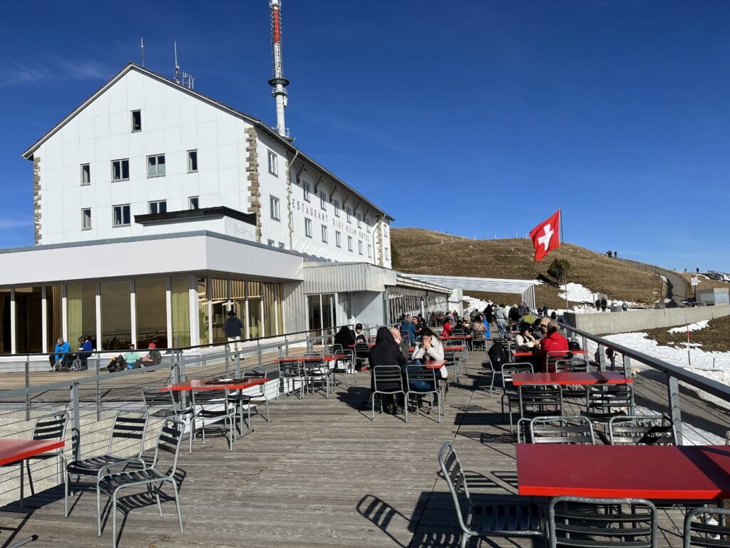 a group of people sitting at tables outside a building