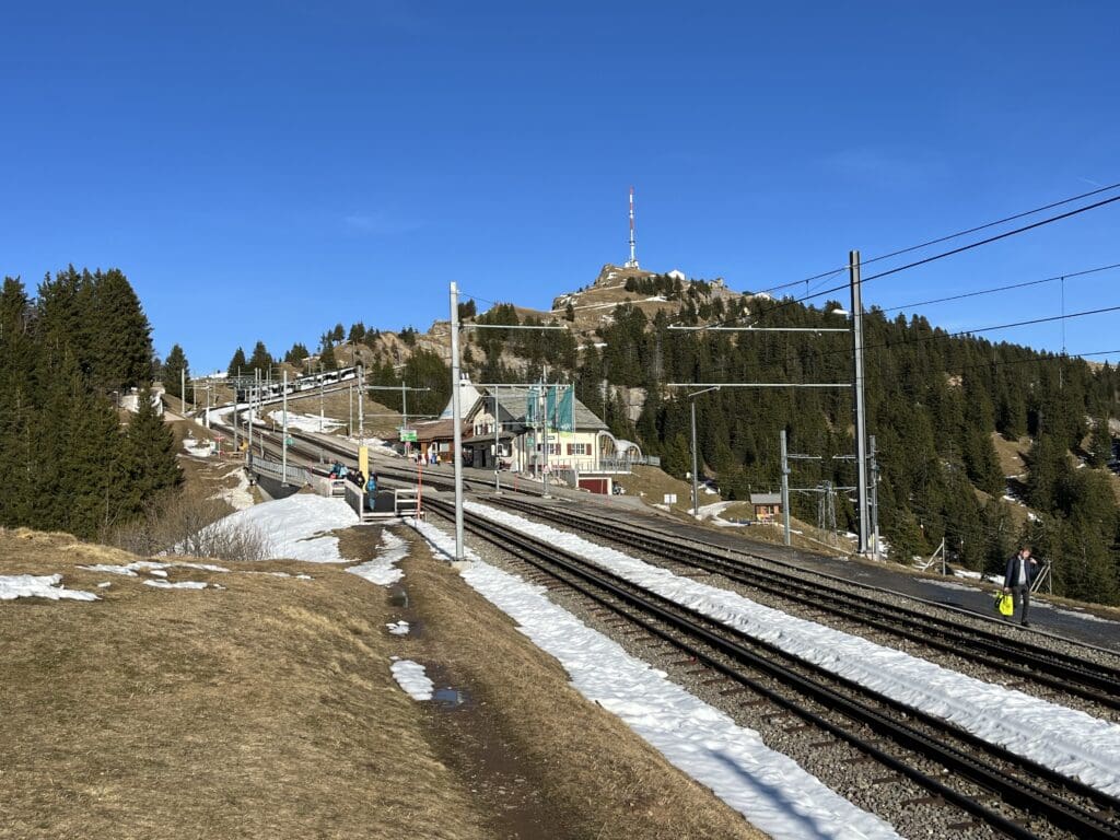 train tracks next to a hill