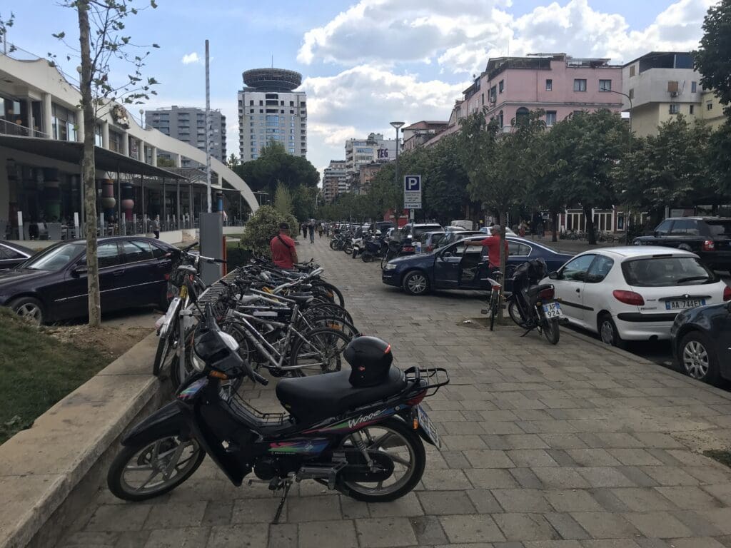 a group of parked motorcycles on a sidewalk in Tirana, Albania