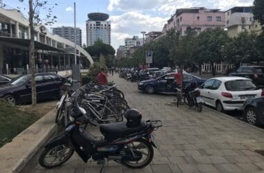 a group of parked motorcycles on a sidewalk