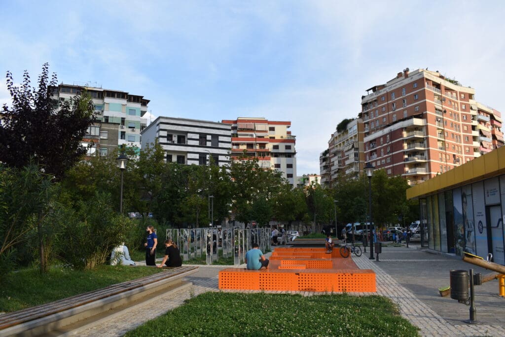 people sitting on benches in a park