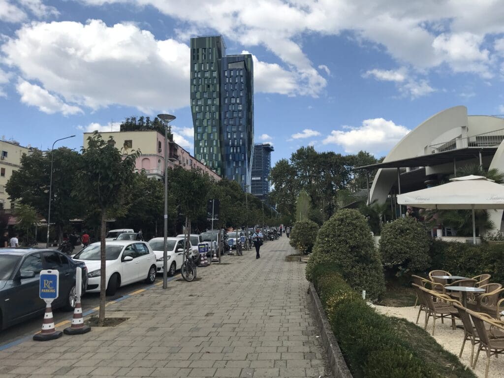 a sidewalk with cars parked on it