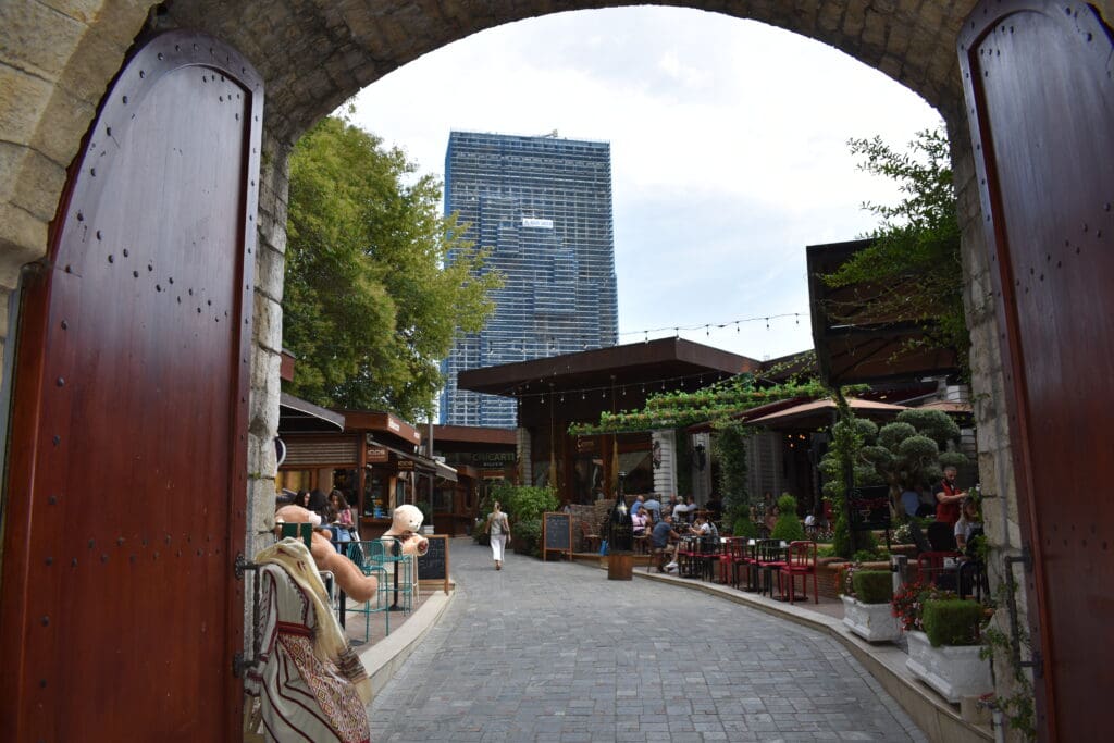 a stone walkway with people walking through it