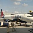 a JetBlue plane parked at an airport