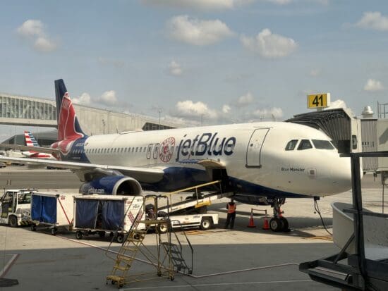 a JetBlue plane parked at an airport