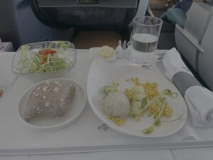 a tray with food and a glass of water on it