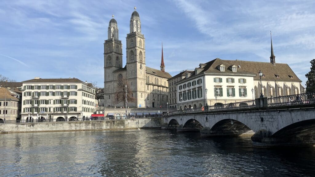 a bridge over water with a stone building and a bridge