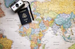 a camera and passport on a map