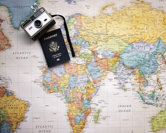 a camera and passport on a map