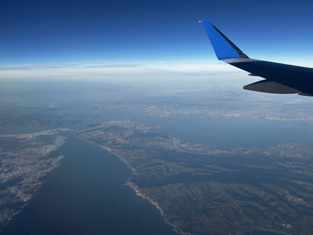 an airplane wing above land