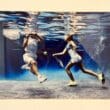 a couple of people playing tennis underwater