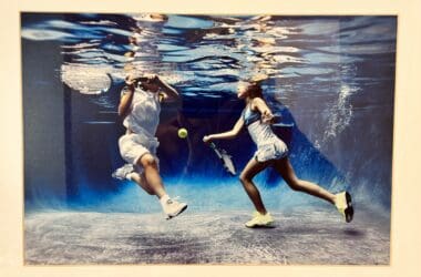 a couple of people playing tennis underwater