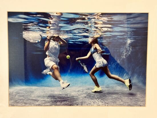 a couple of people playing tennis underwater