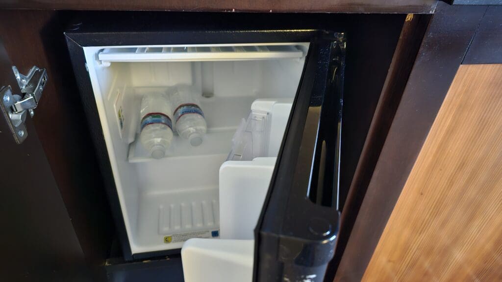 a small refrigerator with bottles inside