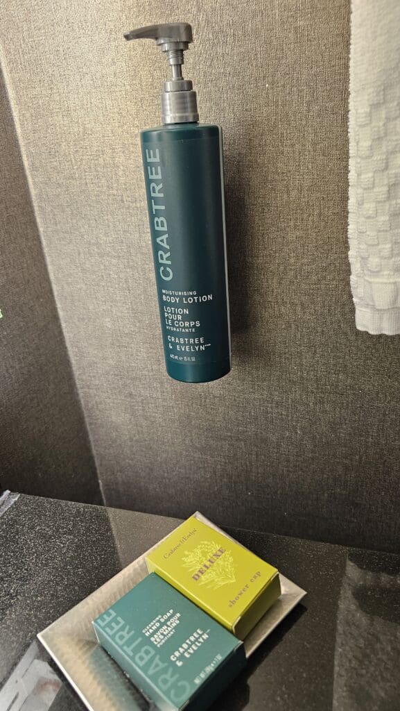 a green tube of body lotion on a wall