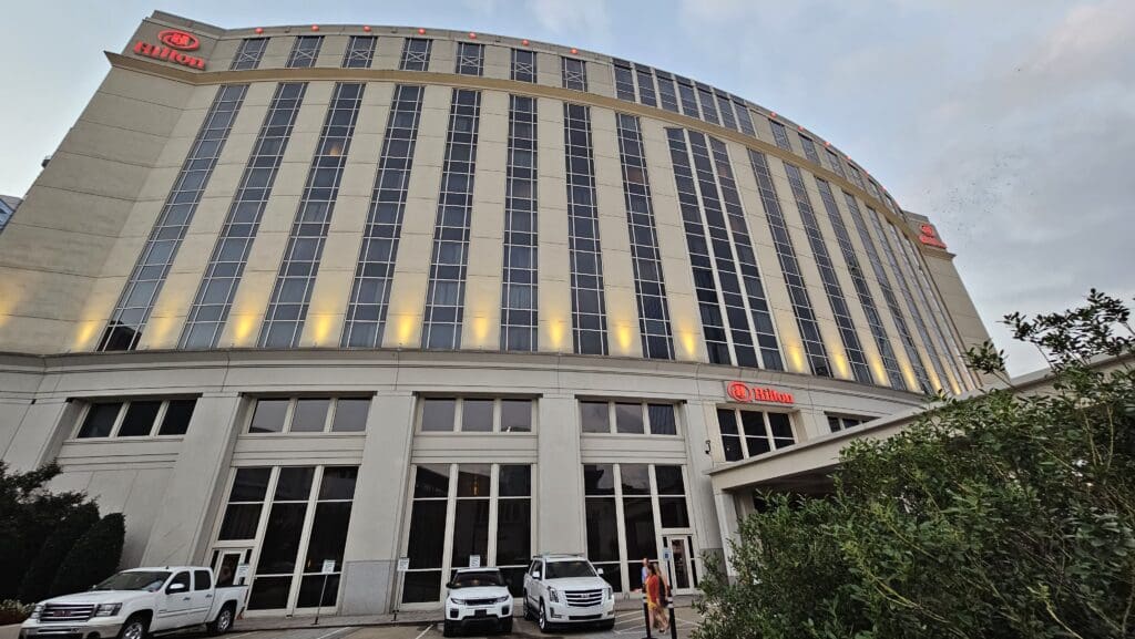 a large circular building with cars parked in front of it