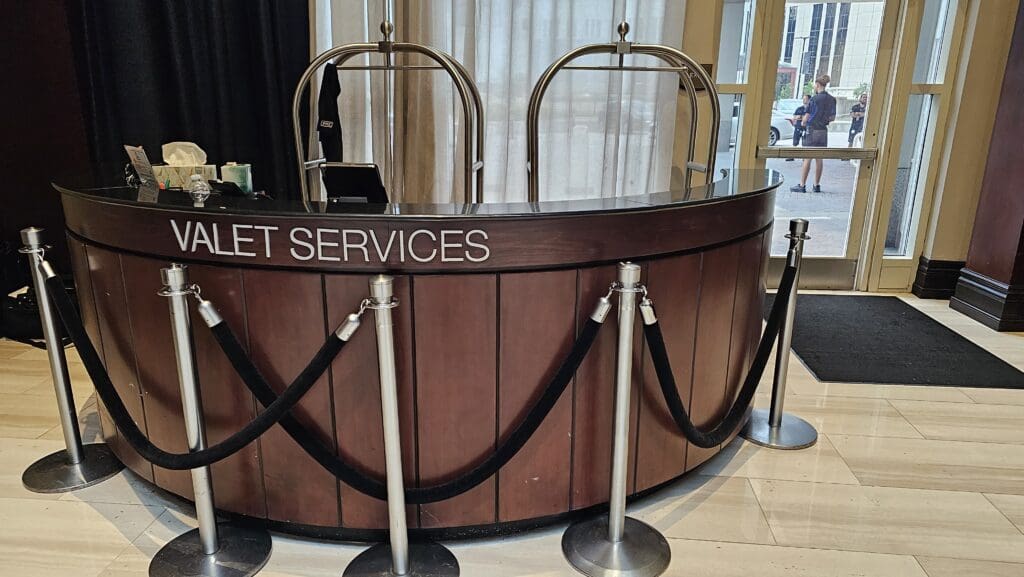 a reception desk with rope barriers