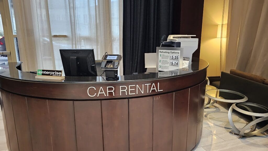 a car rental desk with a cash register and a printer