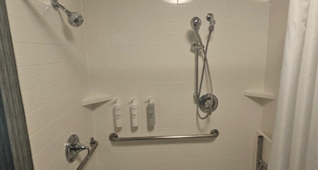 a shower with a bar and shower head