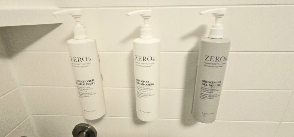 a group of shampoo bottles on a tile wall