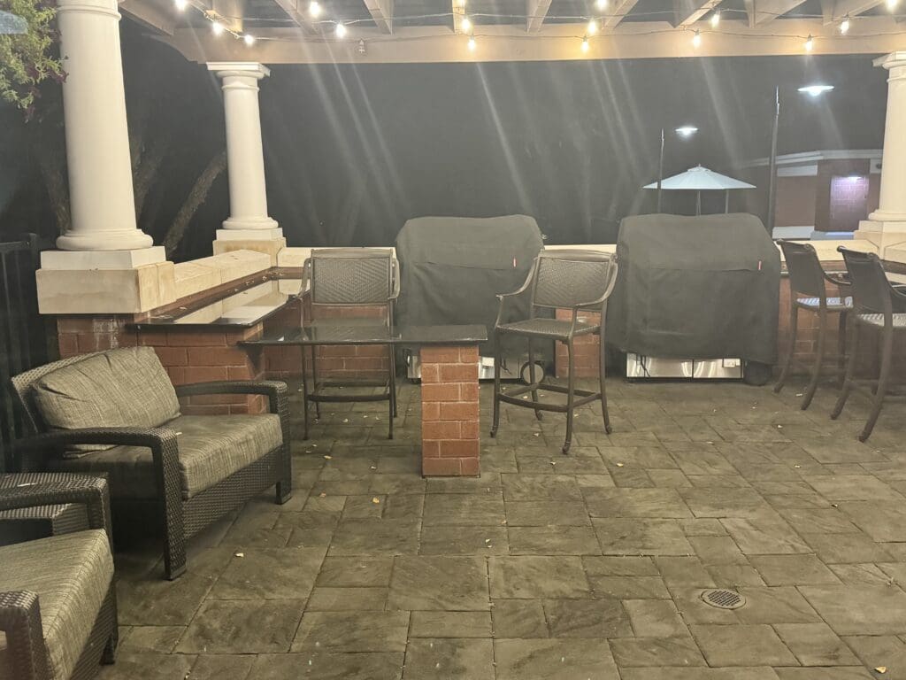 a patio with chairs and a table