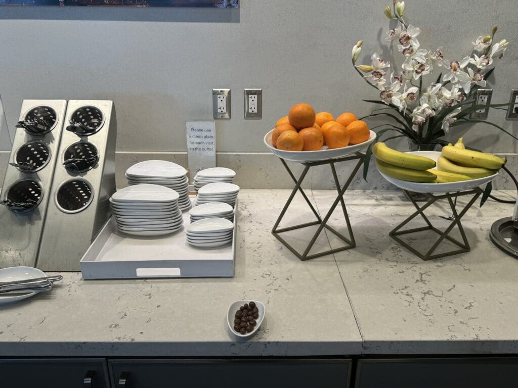 plates and bowls of fruit on a counter