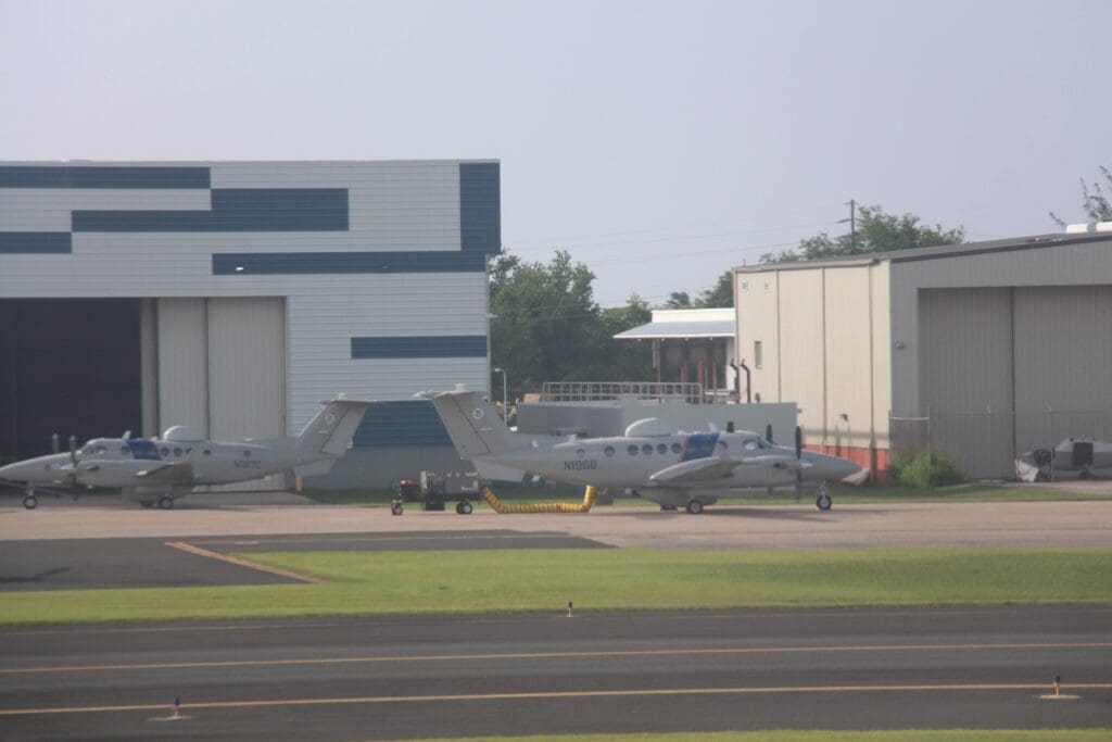 a group of airplanes parked on a runway