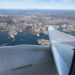 an airplane wing and wing of a city