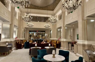 a room with a chandelier and tables