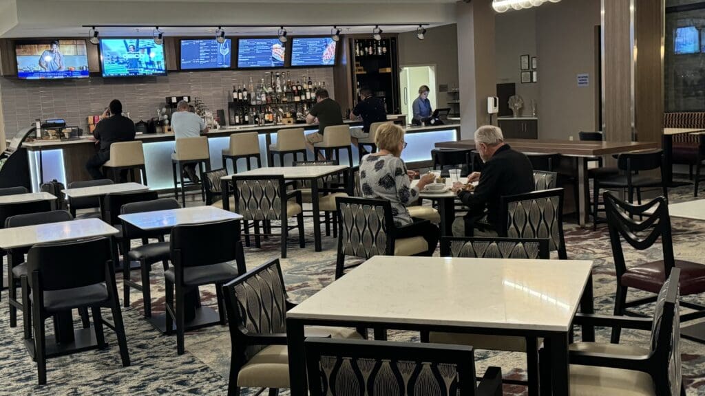 a group of people sitting at tables in a restaurant